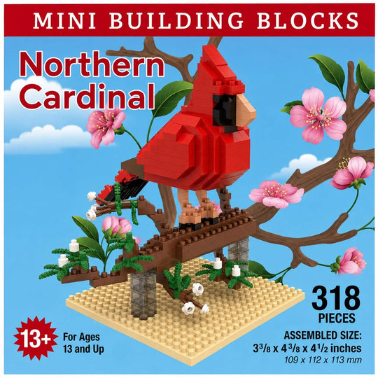 Northern Cardinal mini building blocks set, featuring a red cardinal perched on a brown branch structure with pink blossoms and green leaves on a beige base. The packaging-style graphic includes text reading &