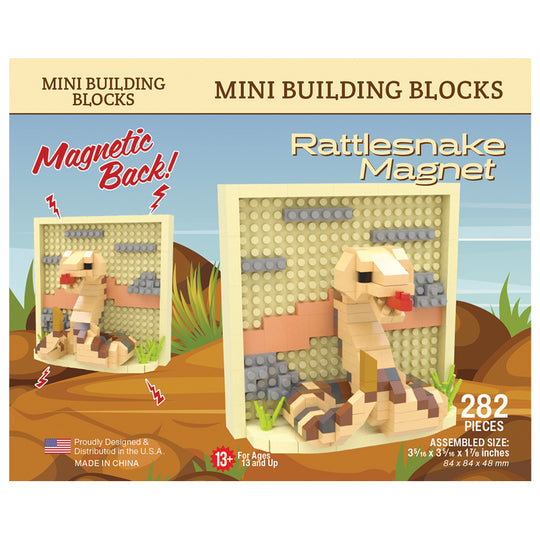 Front packaging of a Mini Building Blocks set featuring a Rattlesnake Magnet, with 282 pieces. The box shows a beige and brown snake built from blocks, a large inset of the assembled magnet on a beige base, and a smaller inset showing the magnetic effect.