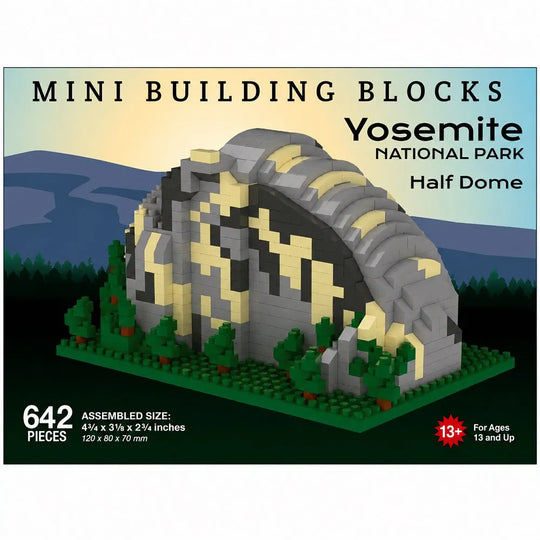 Box front for a mini building blocks set featuring a Yosemite National Park Half Dome structure. The package shows the assembled dome model in gray, black, and beige tones with green trees and blue mountains in the background.