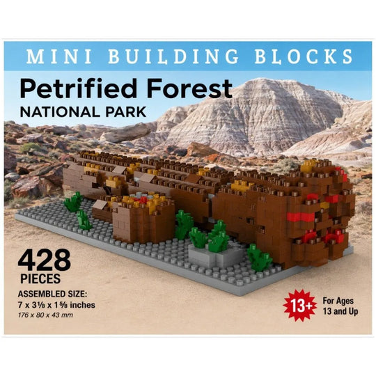 Petrified Forest National Park mini building blocks set, featuring a brown petrified log, green plants, and a gray baseplate, shown against a desert canyon backdrop with product details and piece count text.
