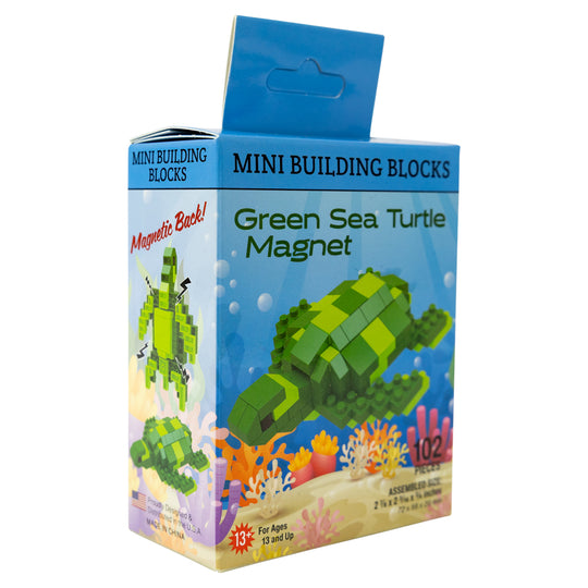 Box of mini building blocks shaped like a green sea turtle magnet on a white background