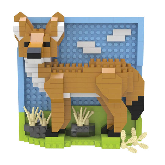 A block-style toy coyote built from interlocking bricks, shown standing on a green base with a blue sky backdrop and small cream grass elements. 