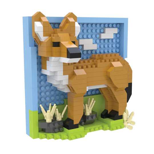 A block-style coyote figurine built from interlocking toy bricks, standing on a green base with a blue wall and white clouds behind it, photographed on a plain white background.