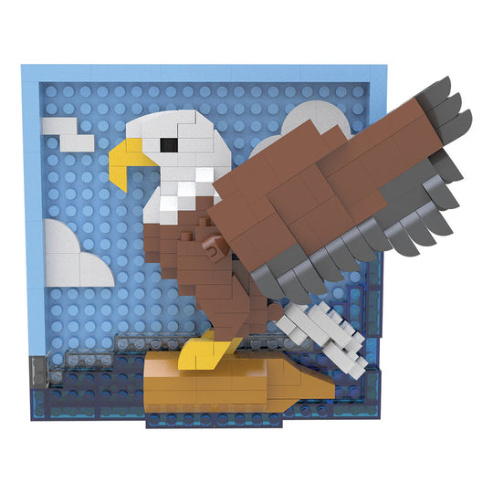 A block-built eagle sculpture posed in front of a blue sky backdrop with white clouds, constructed from interlocking toy bricks.