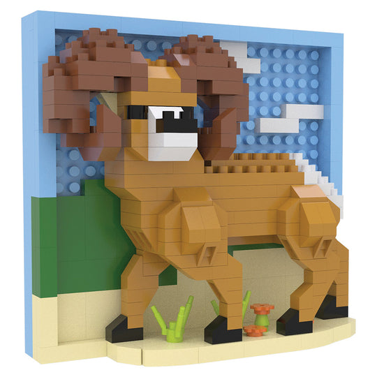 A block-style toy building set depicting a brown ram with large curled horns, standing in front of a blue sky and green hill backdrop on a beige ground with small plants and flowers.