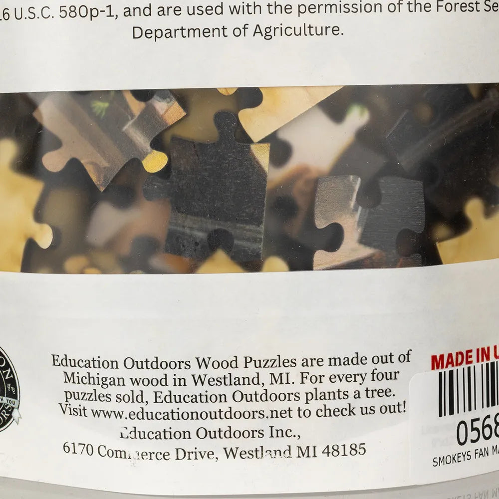 Back of a wooden puzzle with branding and contact information.