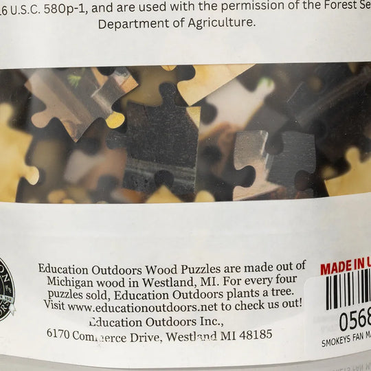 Back of a wooden puzzle with branding and contact information.