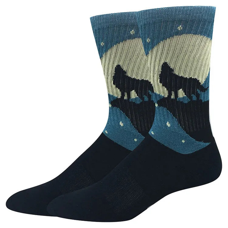 Blue knit socks with a coyote howling beneath a night sky featuring the moon and stars
