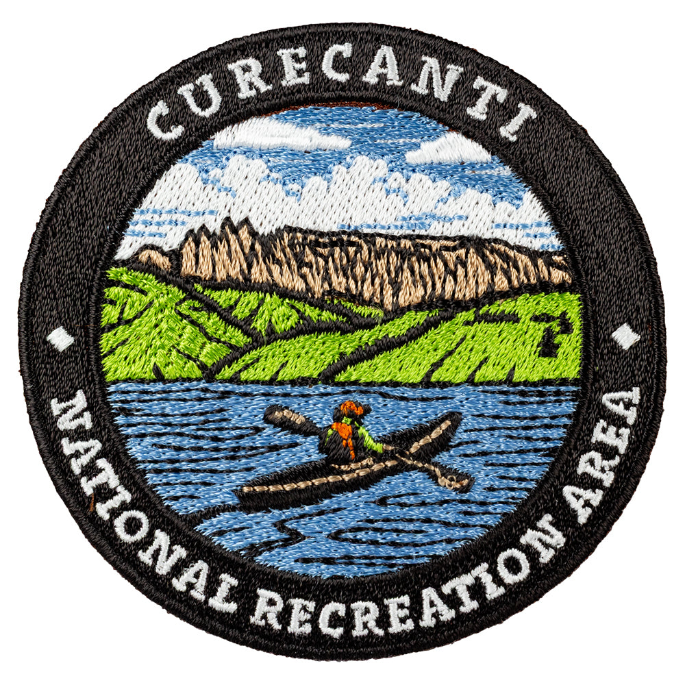 Embroidered patch of Curecanti National Recreation Area with a kayaker and mountain landscape.