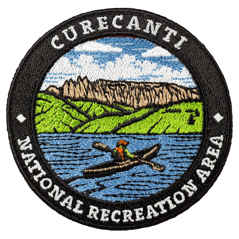 Embroidered patch of Curecanti National Recreation Area with a kayaker and mountain landscape.