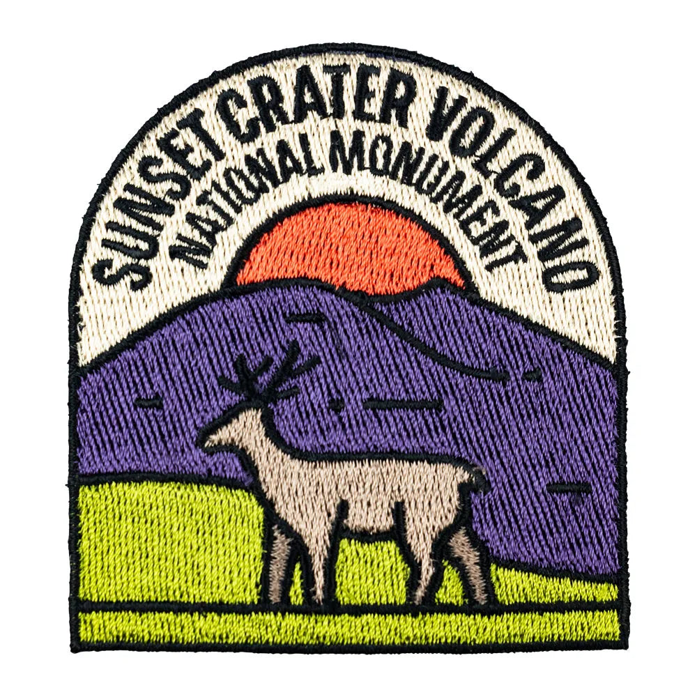 Embroidered patch of Sunset Crater Volcano National Monument with a mountain and deer design.