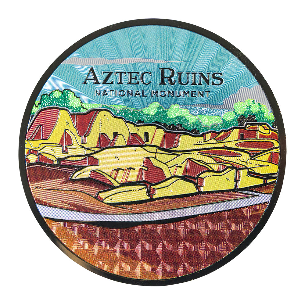 Round sticker with Aztec Ruins National Monument illustration on a white background