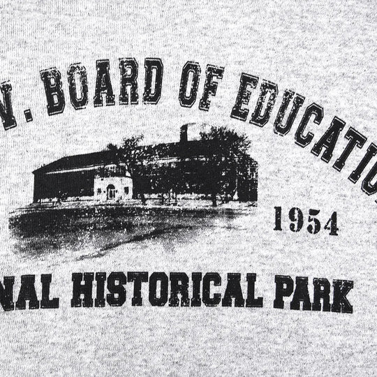 Vintage-style graphic with a building and text 'Board of Education National Historical Park 1954' on a gray background.