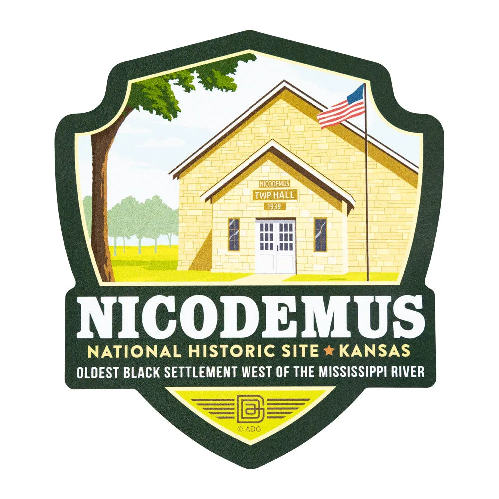 Logo of Nicodemus National Historic Site in Kansas featuring a schoolhouse and American flag.