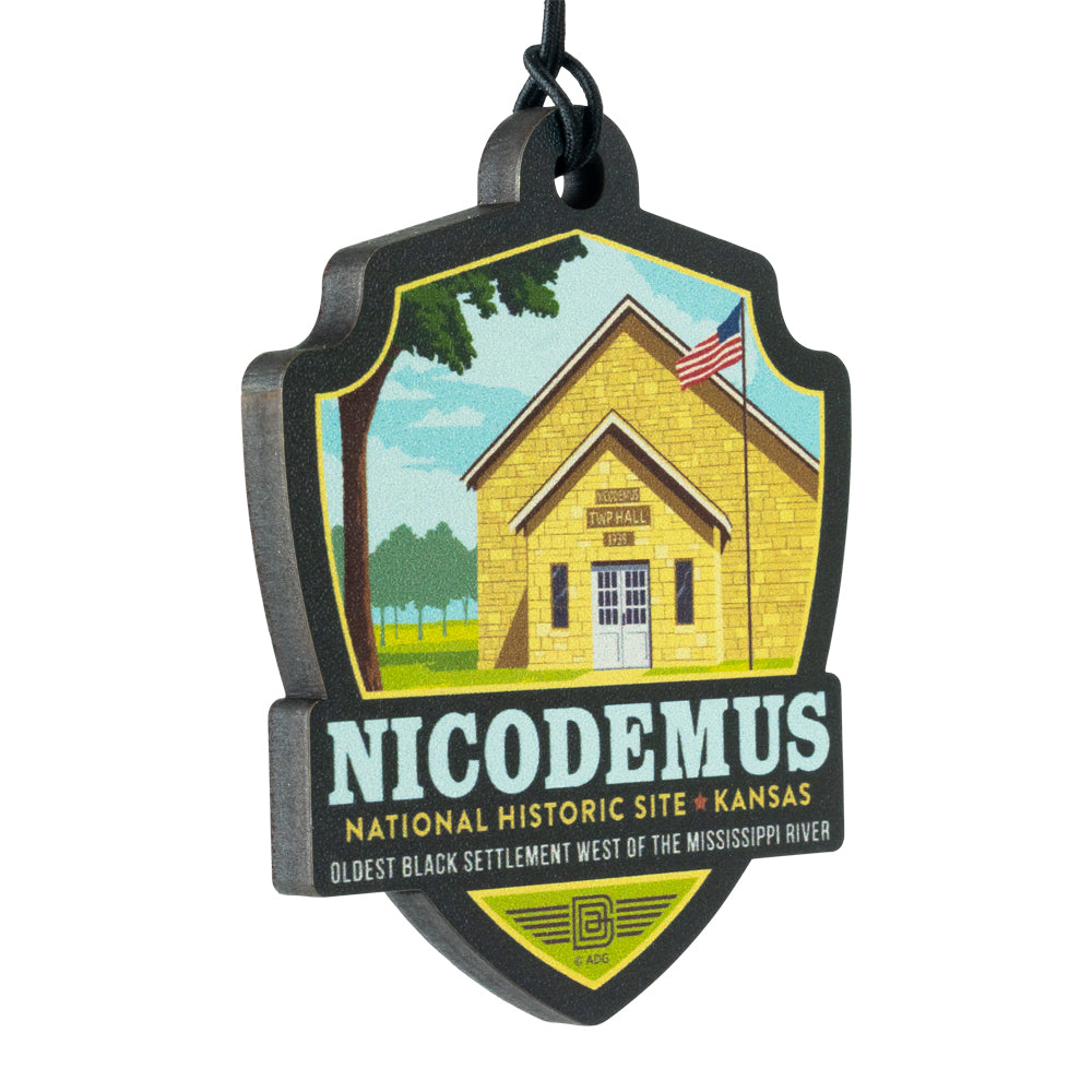 Decorative ornament of Nicodemus National Historic Site in Kansas with a yellow building illustration.