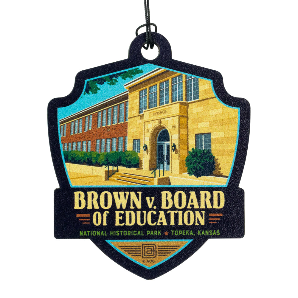 Decorative ornament with a school building and 'Brown v. Board of Education' text on a white background