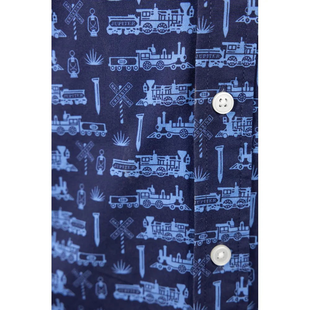 Button and print closeup showing trains, rail spike, crossing sign, and cactus