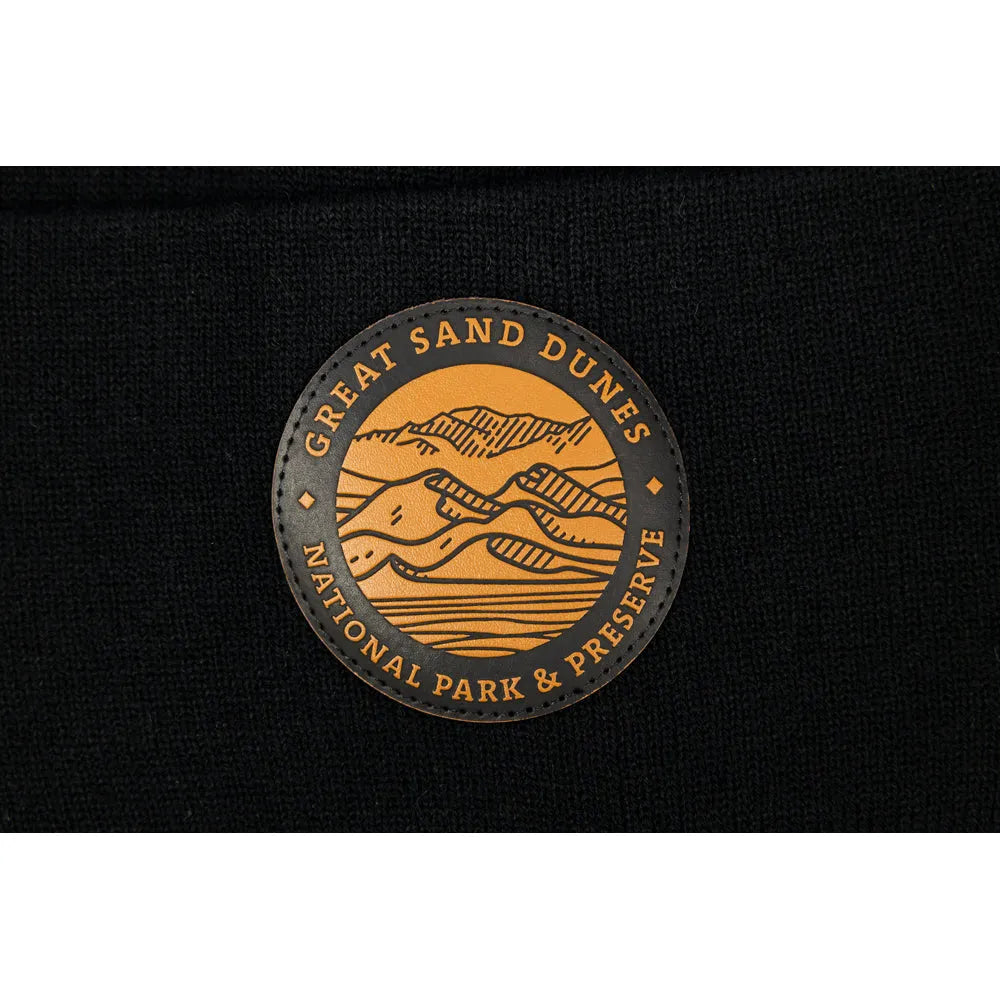 Detail of Great Sand Dunes National Park & Preserve leather patch on black knit beanie