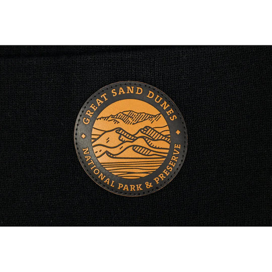 Detail of Great Sand Dunes National Park & Preserve leather patch on black knit beanie