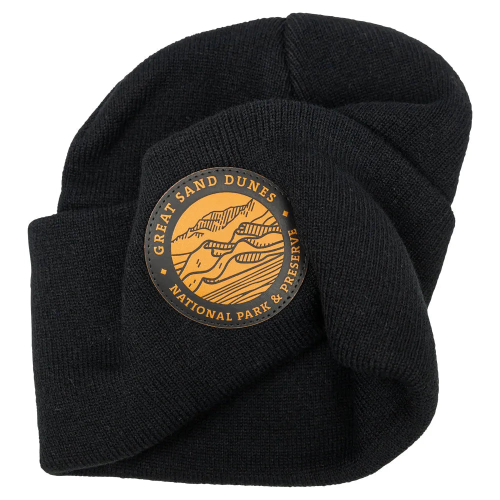 Slightly scrunched black knit beanie with leather patch featuring Great Sand Dunes National Park & Preserve