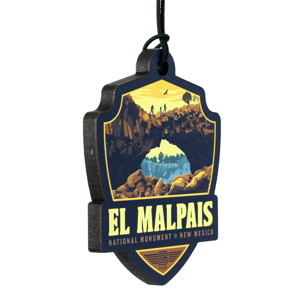 Decorative ornament of El Malpais National Monument with mountain and cave illustration on a white background