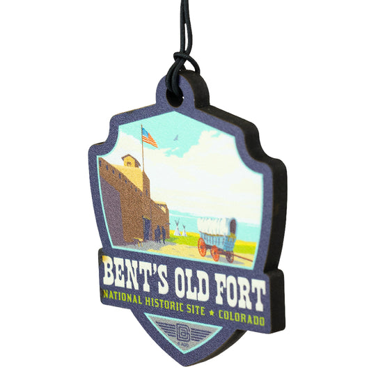 Badge-shaped ornament for Bent's Old Fort National Historic Site with a vintage illustration of a fort and wagon.