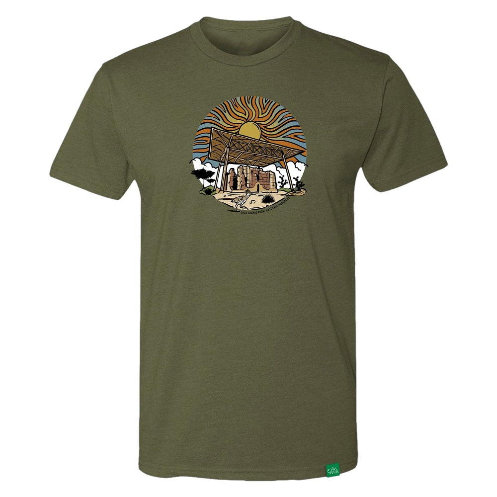 Olive green t-shirt with a graphic design of Casa Grande Ruins National Monument and a sunset on a white background