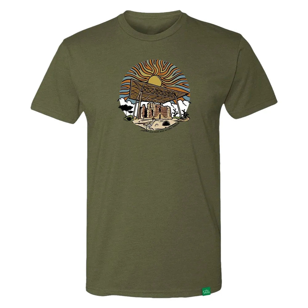Olive green t-shirt with a graphic design of Casa Grande Ruins National Monument and a sunset on a white background