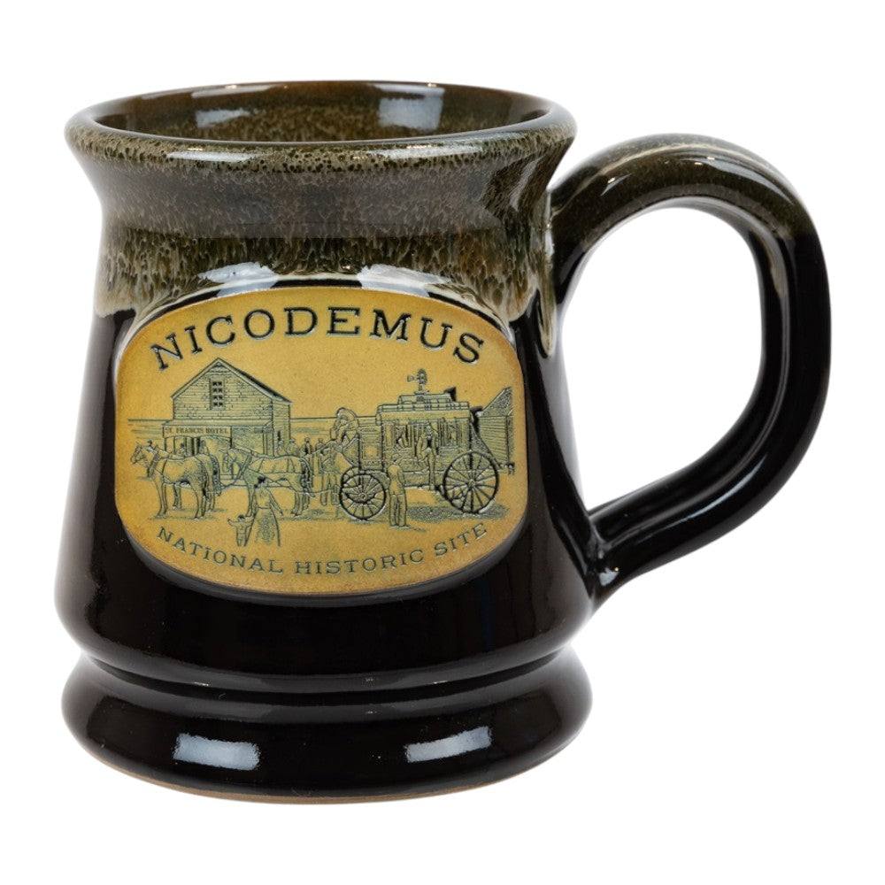 Black ceramic mug with a decorative label featuring 'Nicodemus National Historic Site' on a white background.