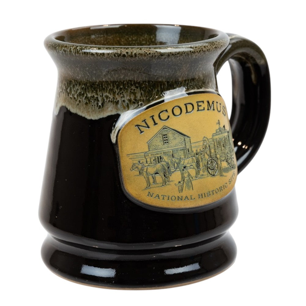 Black ceramic mug with a decorative label featuring 'Nicodemus National Historic Site' on a white background.