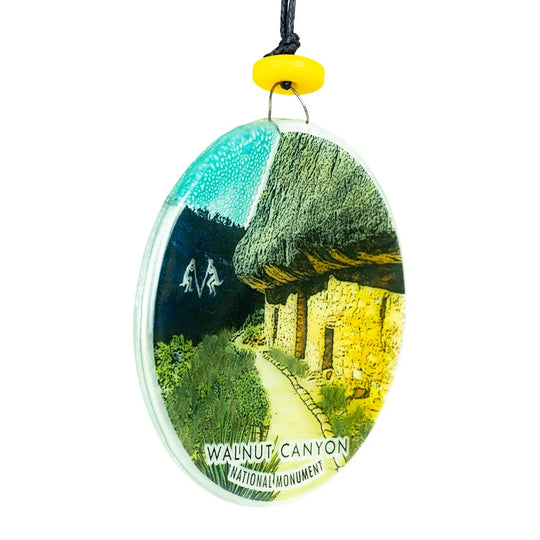 Recycled glass ornament 3/4 view with a scenic image of Walnut Canyon National Monument on a white background