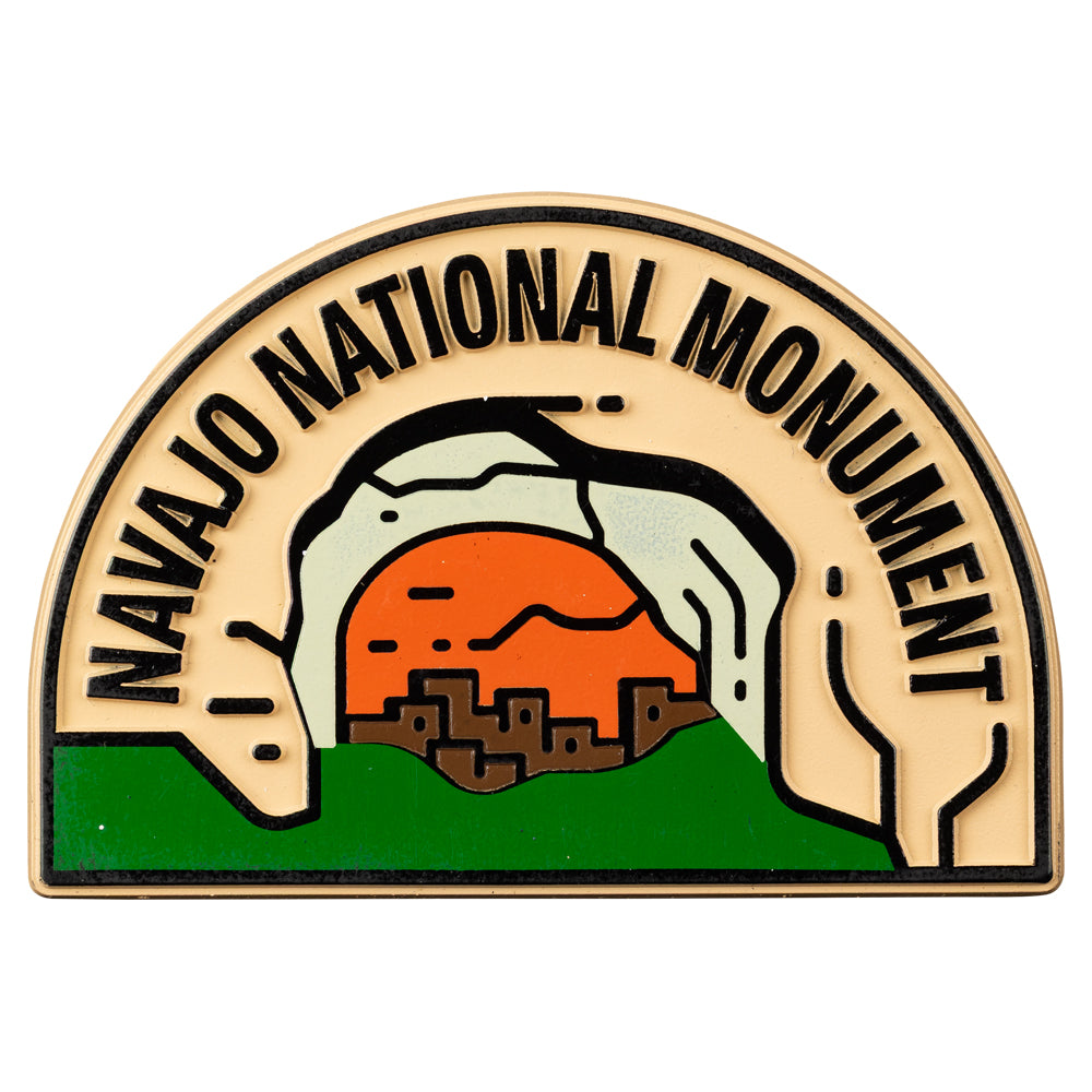 Navajo National Monument badge with desert landscape illustration on a beige background