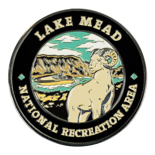 Round coin with 'Lake Mead National Recreation Area' text and mountain landscape illustration.