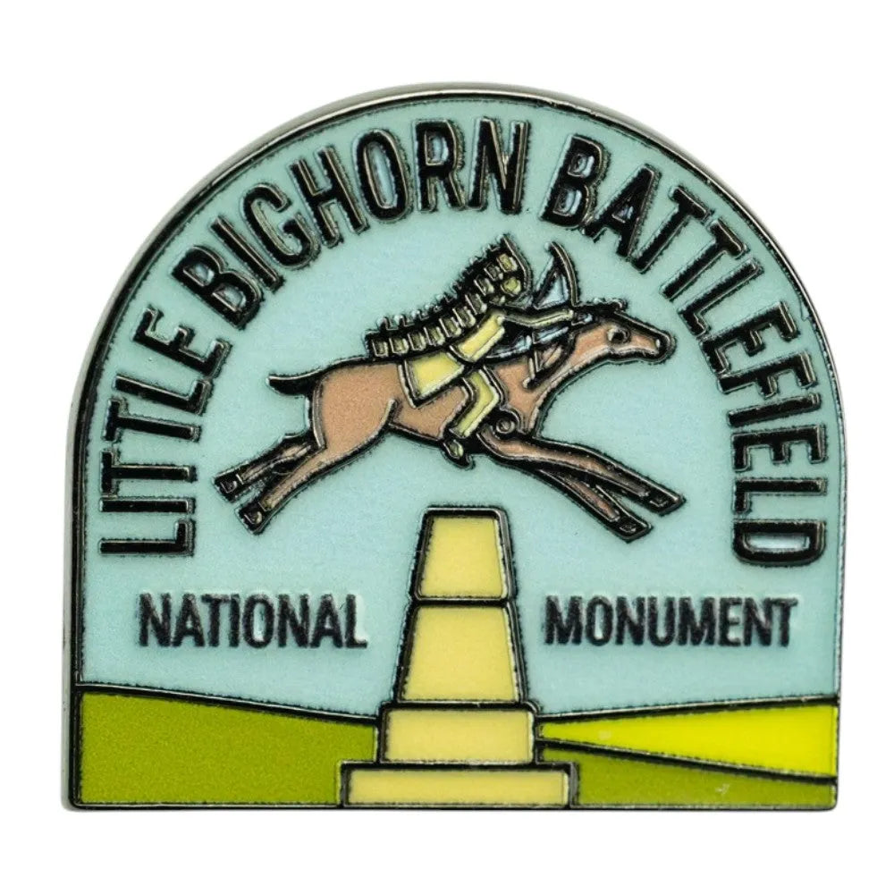 An arched enamel pin featuring a horse and rider jumping over a monument, with the text &