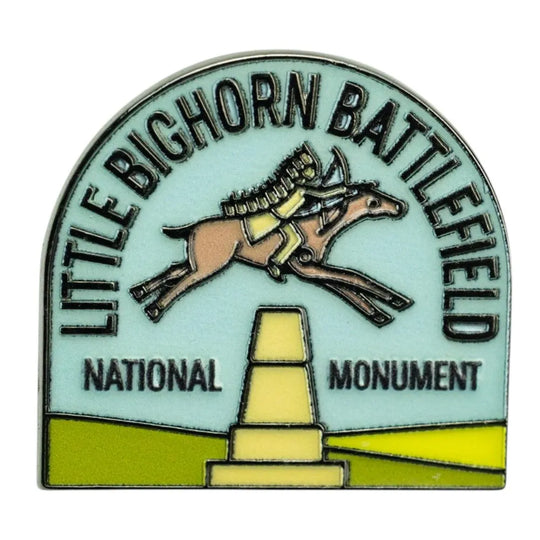 An arched enamel pin featuring a horse and rider jumping over a monument, with the text &