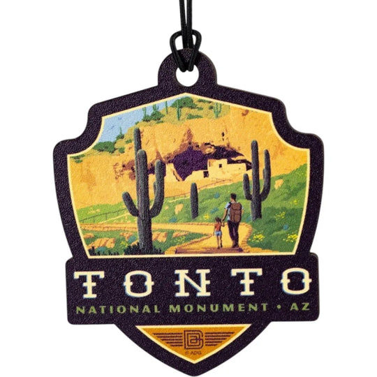 Badge-shaped ornament with Tonto National Monument design featuring a desert scene and cacti.