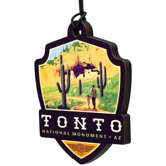 Badge-shaped ornament with Tonto National Monument design featuring a desert scene and cacti.