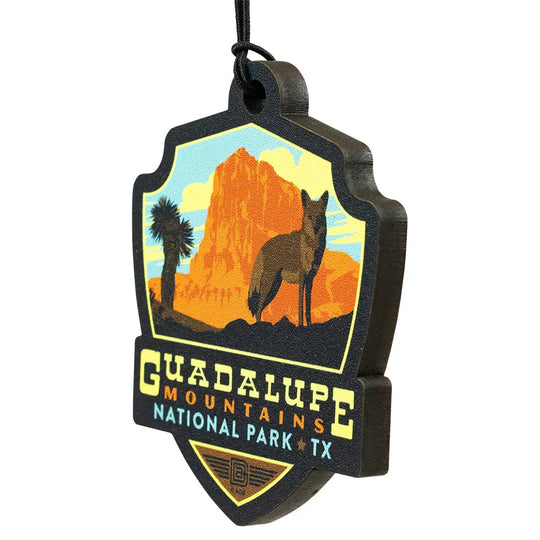 Decorative badge ornament with Guadalupe Mountains National Park design featuring a desert landscape and coyote.