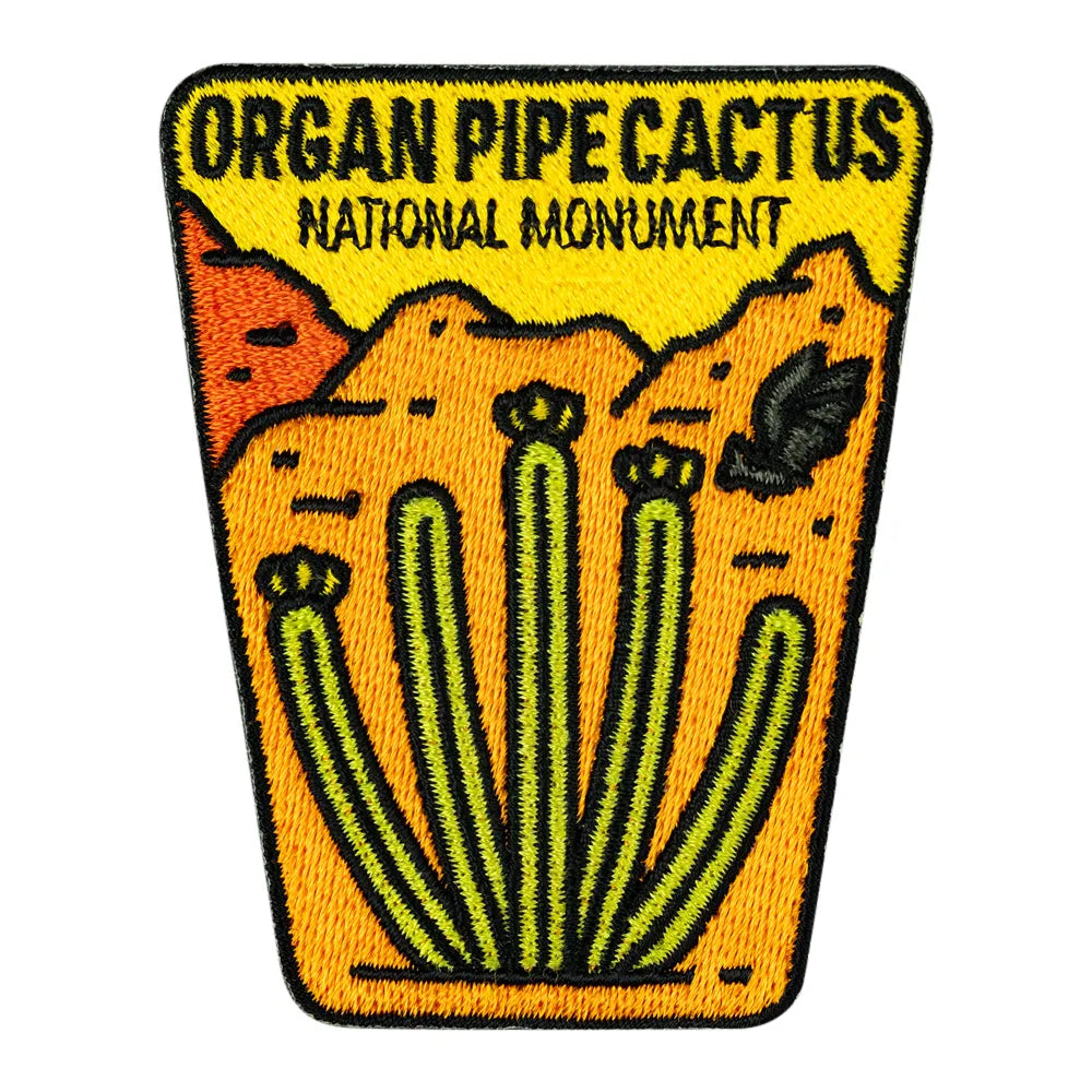 An embroidered patch featuring a stylized desert landscape with the text &