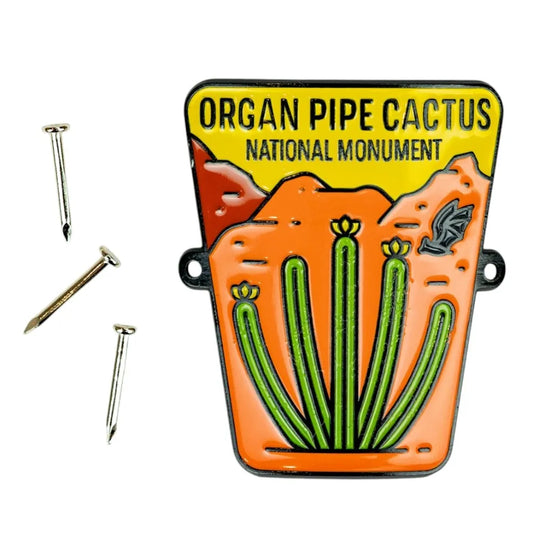 Enamel hiking stick medallion with Organ Pipe Cactus National Monument design on a white background
