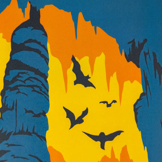 A stylized graphic landscape artwork showing dark blue cliffs or trees against a bright yellow and orange sky, with several black bat silhouettes flying across the scene.