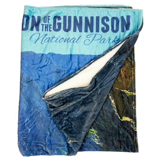Folded blanket with 'Black Canyon of the Gunnison National Park' text on a white background