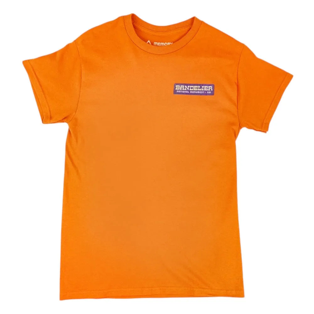 Orange t-shirt with a small logo for Bandelier National Monument in the upper left chest on a white background