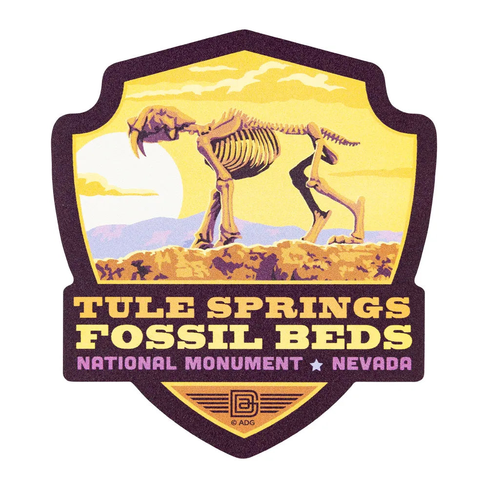 Sticker of Tule Springs Fossil Beds National Monument with saber-toothed tiger skeleton illustration.