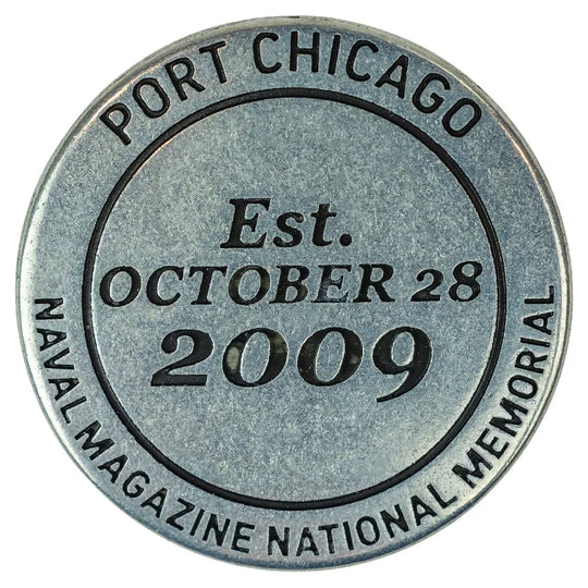 Metal collectible token with 'Port Chicago Naval Magazine National Memorial' text on a white background