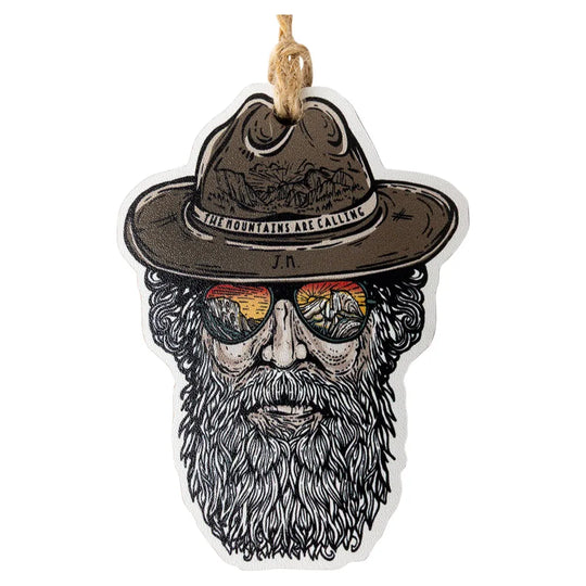 Ornament with a design of a bearded man wearing a hat and sunglasses with 'The mountains are calling' text on the hat.