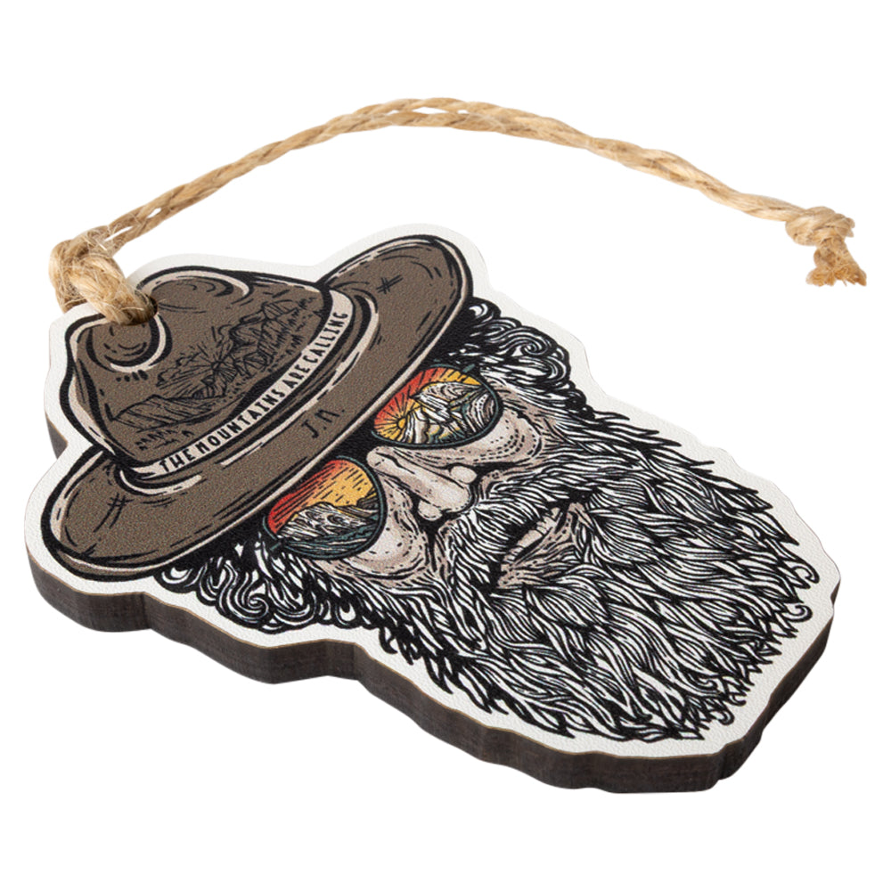 Ornament with a design of a bearded man wearing a hat and sunglasses with 'The mountains are calling' text on the hat.