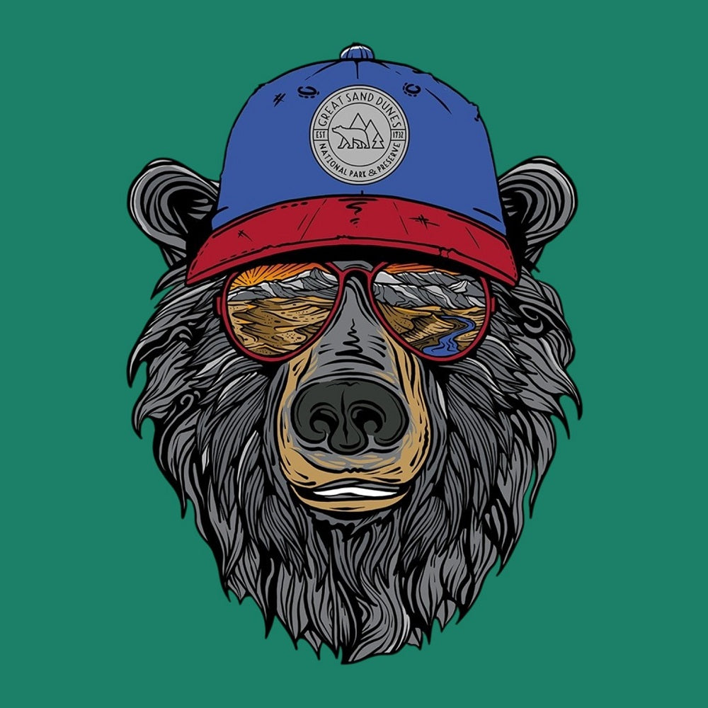 Illustration of a bear wearing a blue and red cap featuring text 'Great Sand Dunes National Park & Preserve' and sunglasses with a landscape reflected in them on a green background