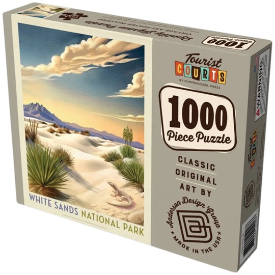 A 1000-piece jigsaw puzzle box by Tourist Courts, featuring artwork of White Sands National Park with sand dunes, yucca plants, mountains, and a blue sky with clouds.
