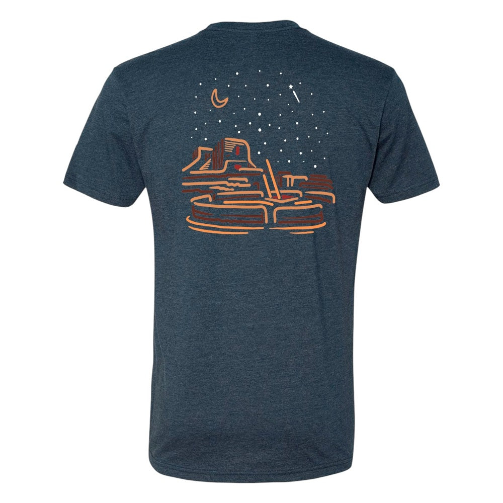 Blue t-shirt with a graphic desert night sky design on the back against a white background